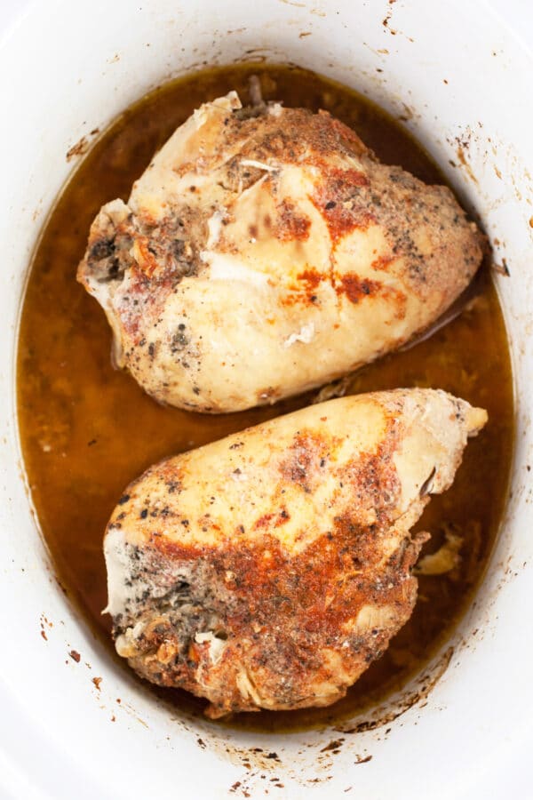 Cooked split chicken breasts in crockpot.