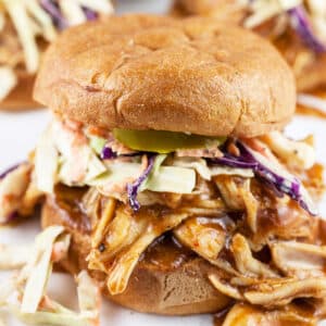 Shredded BBQ chicken sandwiches with coleslaw on toasted buns.